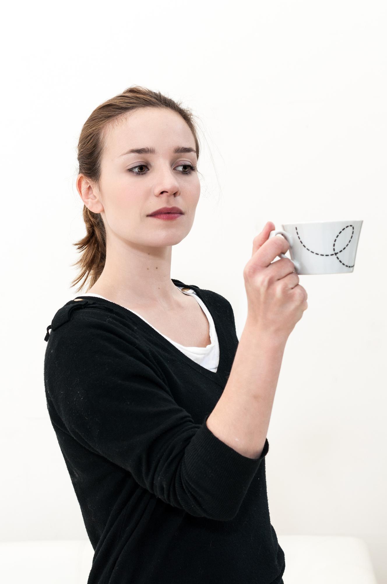 Instructor holding embroidered sample